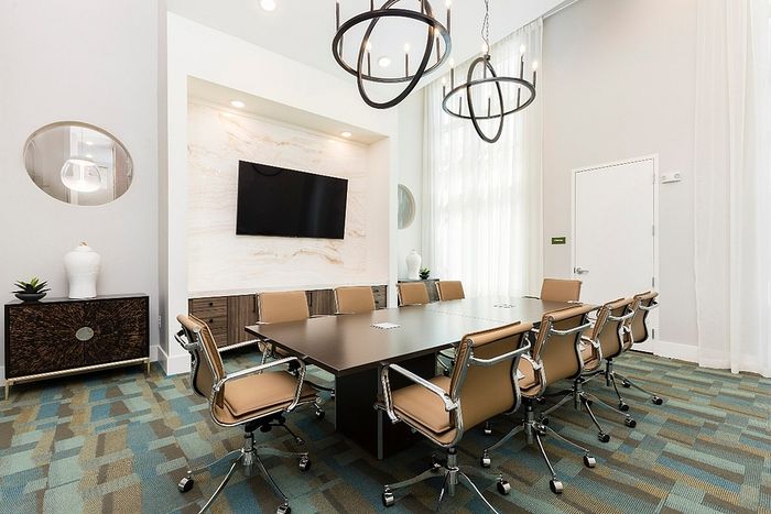 Elegant meeting room with a modern conference table, chic leather chairs, and stylish lighting fixtures.