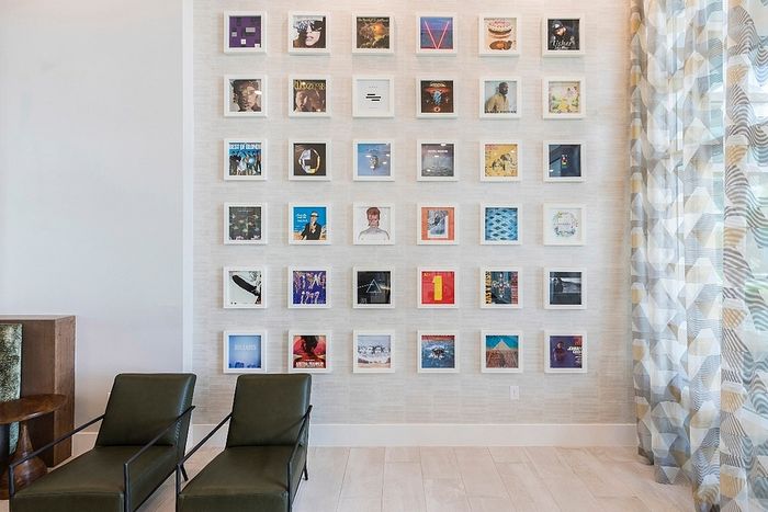 Chic interior featuring a vibrant wall of framed art and sleek, modern seating in a stylish living area.