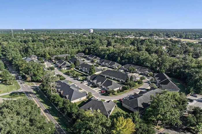 Charming apartment community nestled in a lush green landscape with beautifully maintained streets and modern architecture.