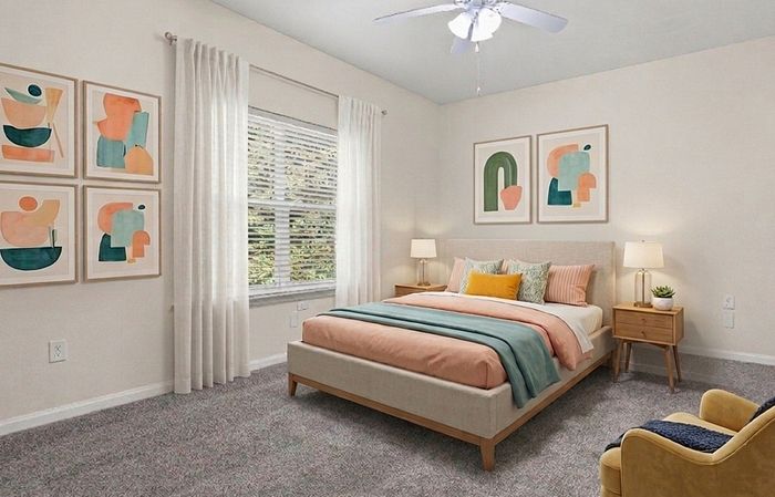 Inviting bedroom with modern decor, featuring a cozy bed with colorful pillows, stylish abstract artwork, and soft natural light filtering through large windows.