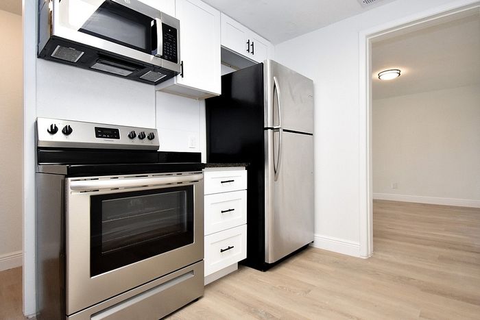 Modern kitchen with sleek stainless steel appliances and stylish cabinetry in a bright, open space.