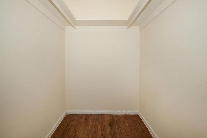 Cozy nook with elegant hardwood flooring, ideal for creative storage solutions.