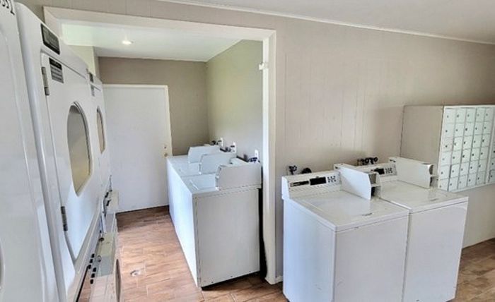 Bright and efficient laundry room with modern washers and dryers, offering convenience in a well-maintained communal space.
