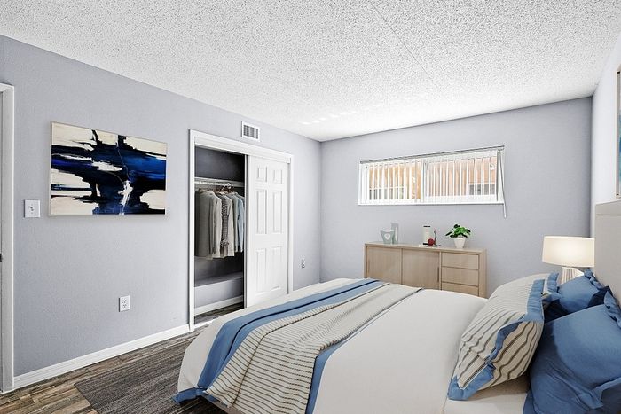 Bright and modern bedroom featuring stylish decor, large wardrobe, and elegant furnishings for a serene living space.