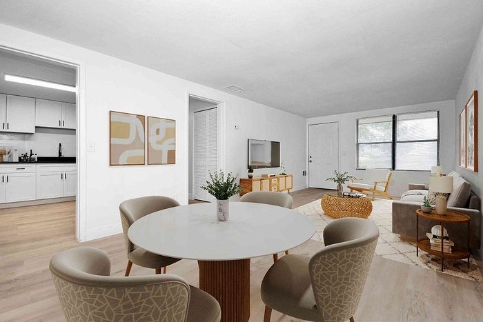 Modern living space with elegant dining area, cozy lounge, and stylish open kitchen design.