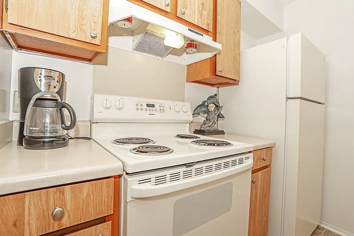Charming kitchen with wood cabinetry, modern appliances, and warm, inviting decor.