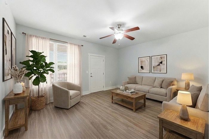 Chic living room with cozy beige sofas, elegant wooden furniture, and abundant natural light perfect for relaxation.