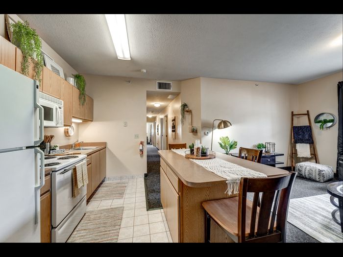 Kitchen with breakfast bar in apartment at University Gate | Erie, PA Apartments.
