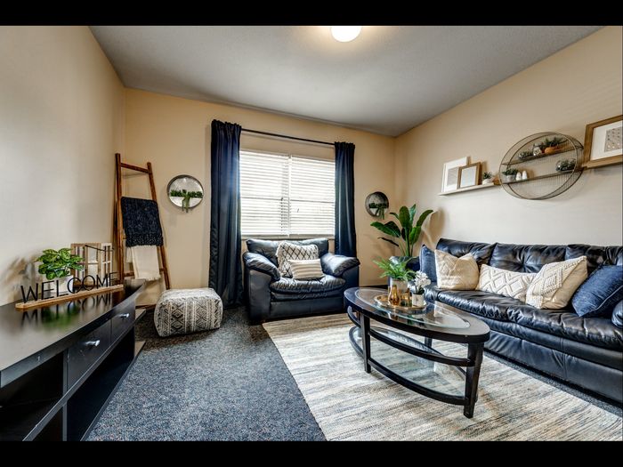 Spacious living room with large window in apartment at University Gate | Erie, PA Apartments.