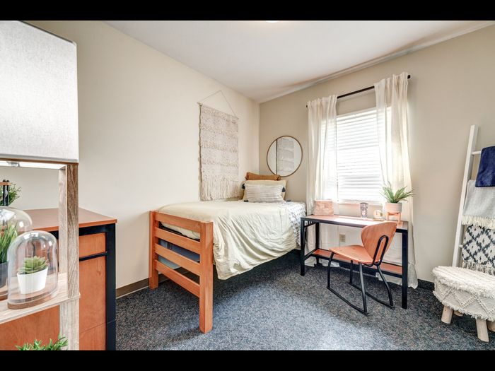 Bedroom with desk & chair, bed, storage in apartment at University Gate | Erie, PA Apartments.