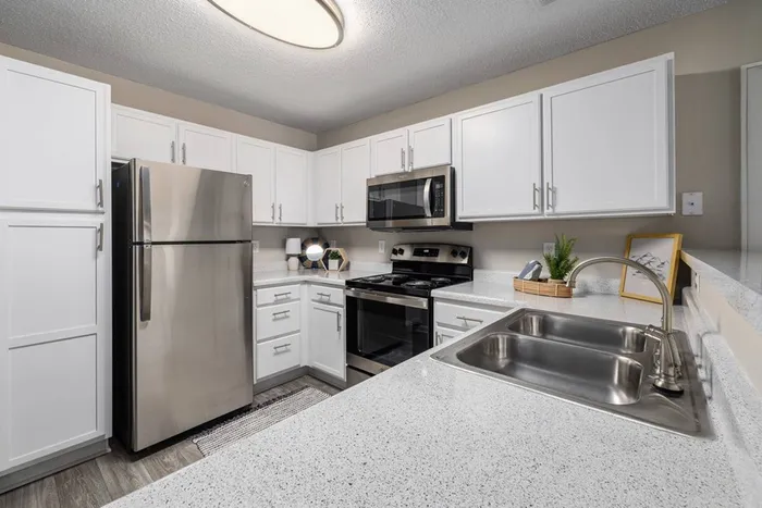 Kitchen with stainless steel appliances and white cabinets