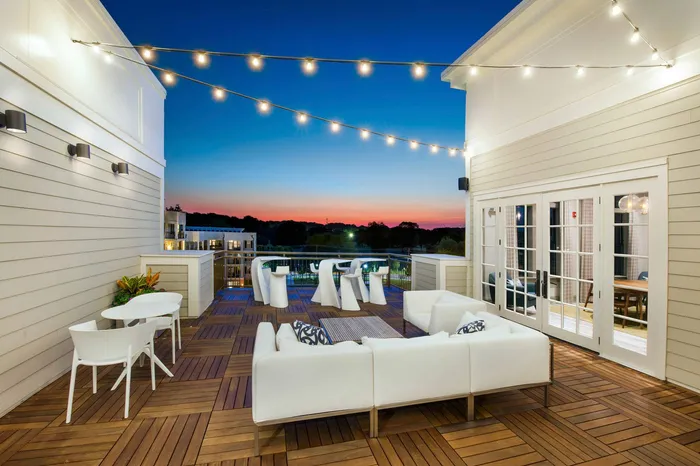 furnished rooftop patio area at nighttime
