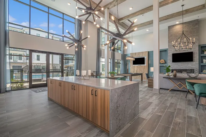 furnished clubroom with kitchen island and high ceilings