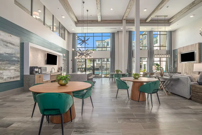 furnished clubroom with kitchen, seating and tables