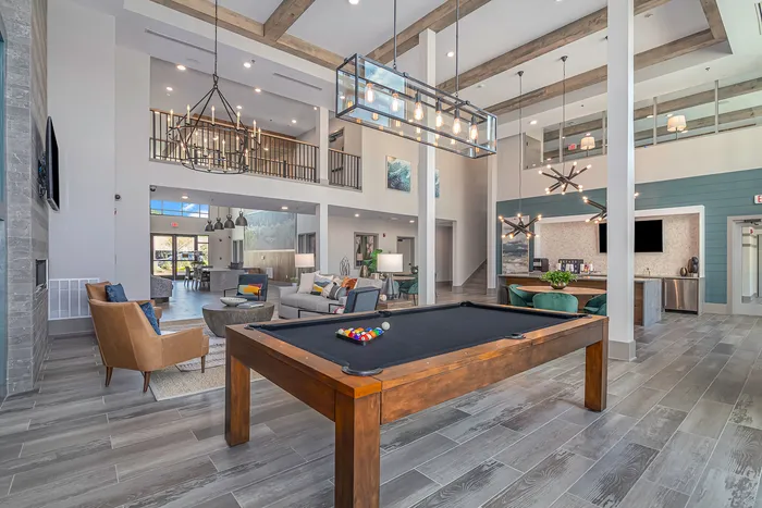 furnished clubroom with billiards table, seating and tables