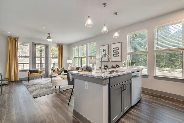 furnished kitchen island and living area in apartment home