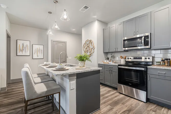 furnished kitchen with island in apartment home