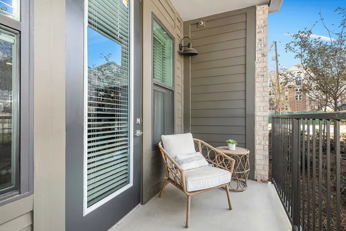 furnished patio area with armchair on sunny day