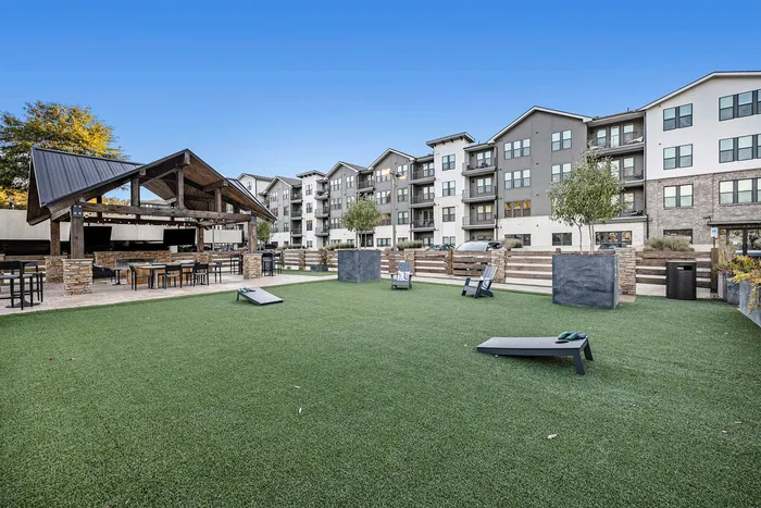 Exterior game space with cornhole boards