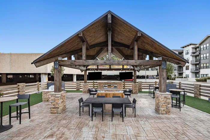 Outdoor dining area with TVs and tables