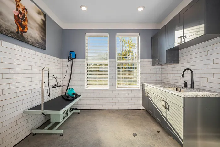 Birmingham, AL Apartments Near Cracker Barrel - Tributary Rise - Pet Spa With Grooming Area, Sink, Counterspace, Grey Cabinets, Tiled Walls, And Windows With Blinds.