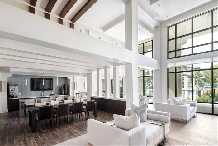 furnished clubroom with seating and kitchen