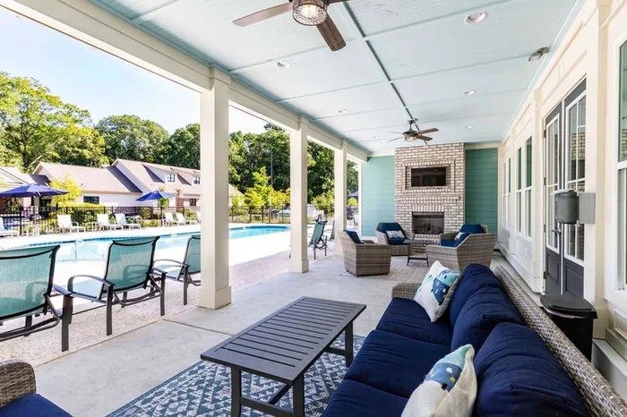 Community outdoor patio with furniture facing pool