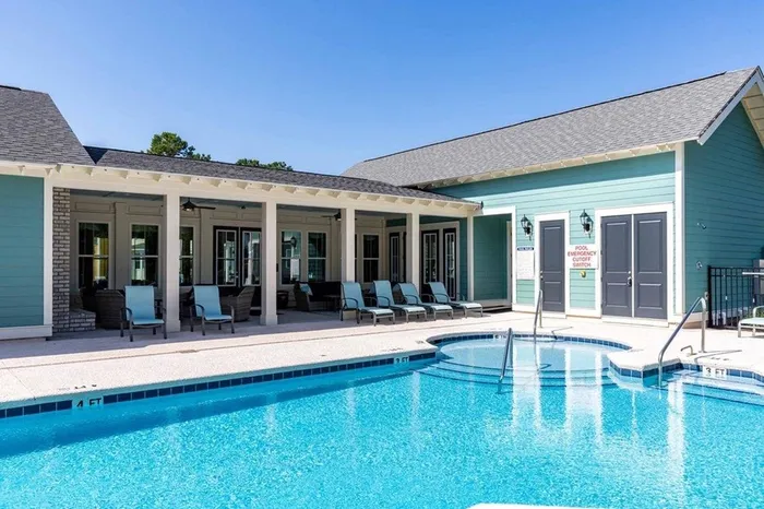 Community pool facing blue clubroom building