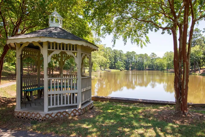 pergola patio area next to lake on sunny day