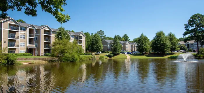 exterior apartment building and lake on sunny day