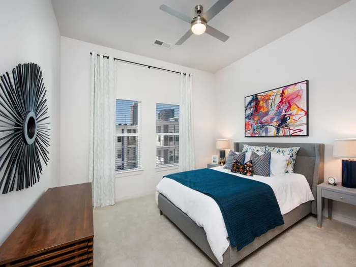 Luxury Apartments For Rent In Atlanta, GA - Spectrum on Spring - Spacious Bedroom With Plush Carpeting, Ceiling Fan, And Windows For Natural Light