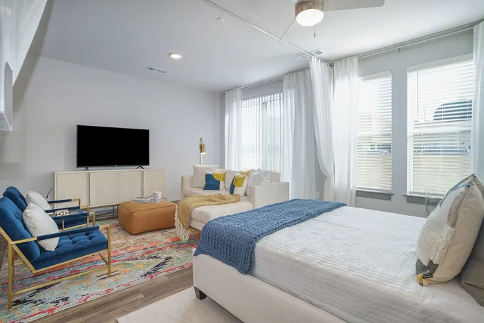 Furnished studio with bed and living room furniture