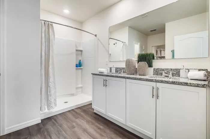 furnished bathroom with countertop and shower