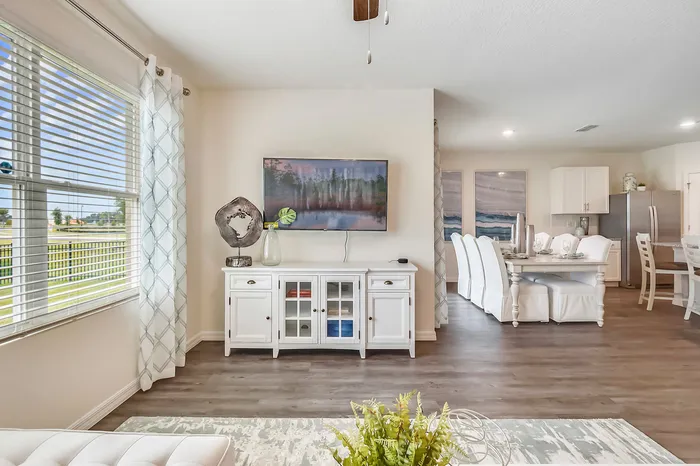 furnished living area with television and console table in home