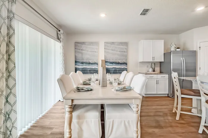 furnished dining area with table and seating in home