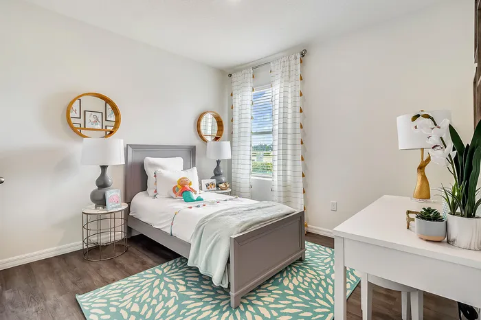 furnished bedroom with bed and desk in home