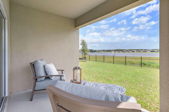 furnished outdoor patio area in backyard of home on sunny day