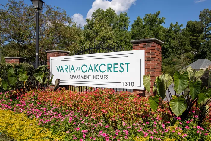 Community sign surrounded by blooming flowers