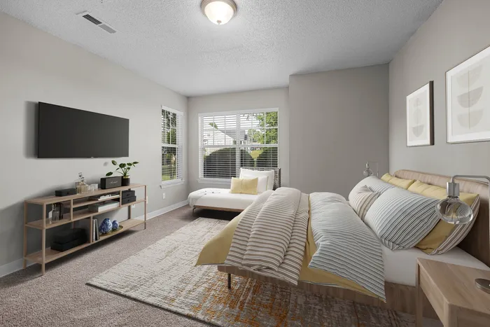 Furnished bedroom with windows, built in ceiling light, and bed