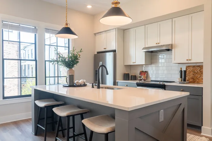 Furnished kitchen with large island and chairs
