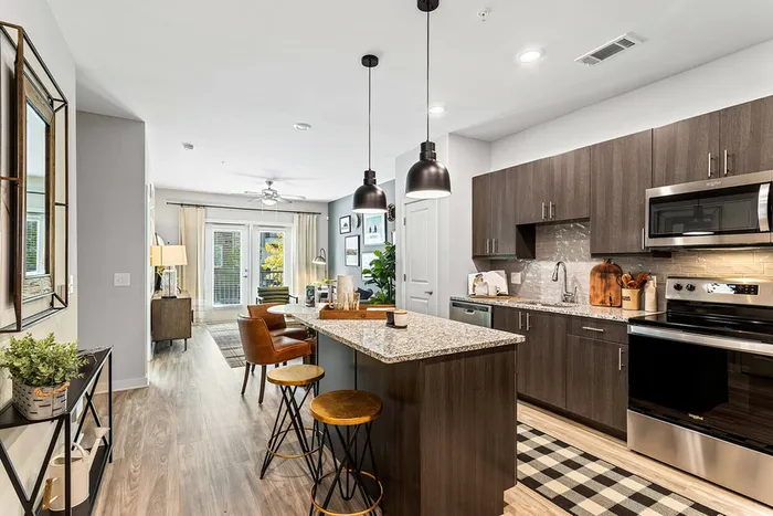 furnished kitchen and living area in apartment home