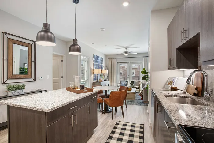 furnished kitchen area with island and living space in apartment home