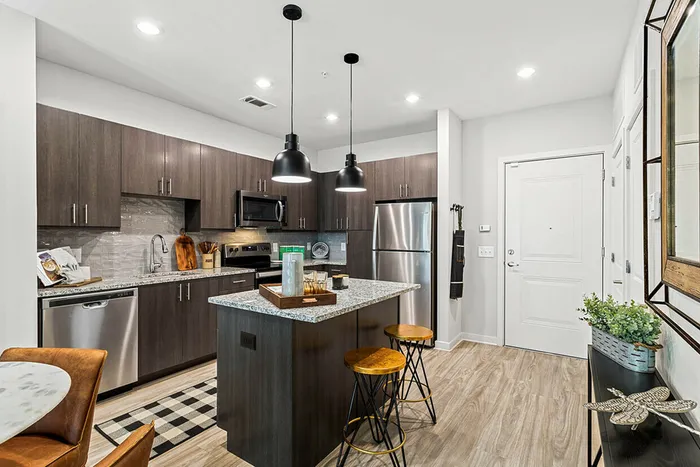 furnished kitchen area with island in apartment home