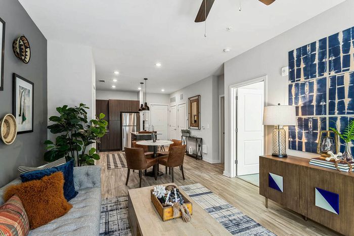 furnished kitchen and living area with island in apartment home