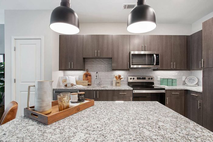 furnished kitchen area with island in apartment home