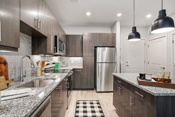 furnished kitchen area with island in apartment home