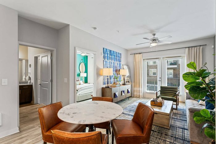furnished dining area and living area in apartment building