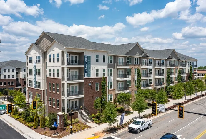exterior apartment building and street on sunny day