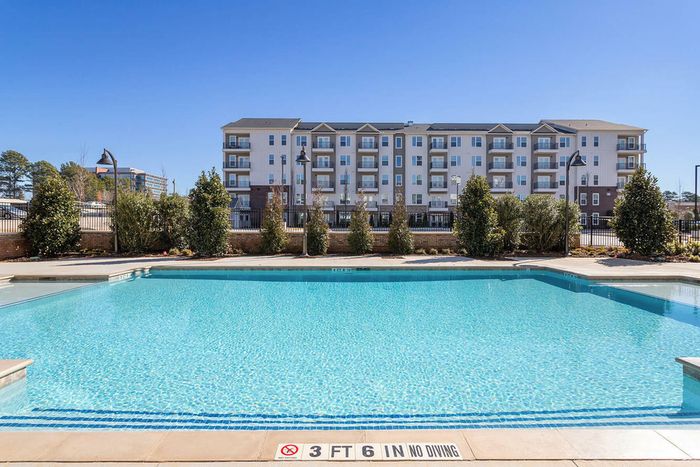 exterior pool and apartment building on sunny day