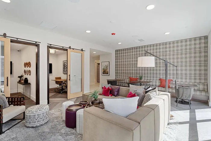 furnished clubhouse area with seating and privacy rooms